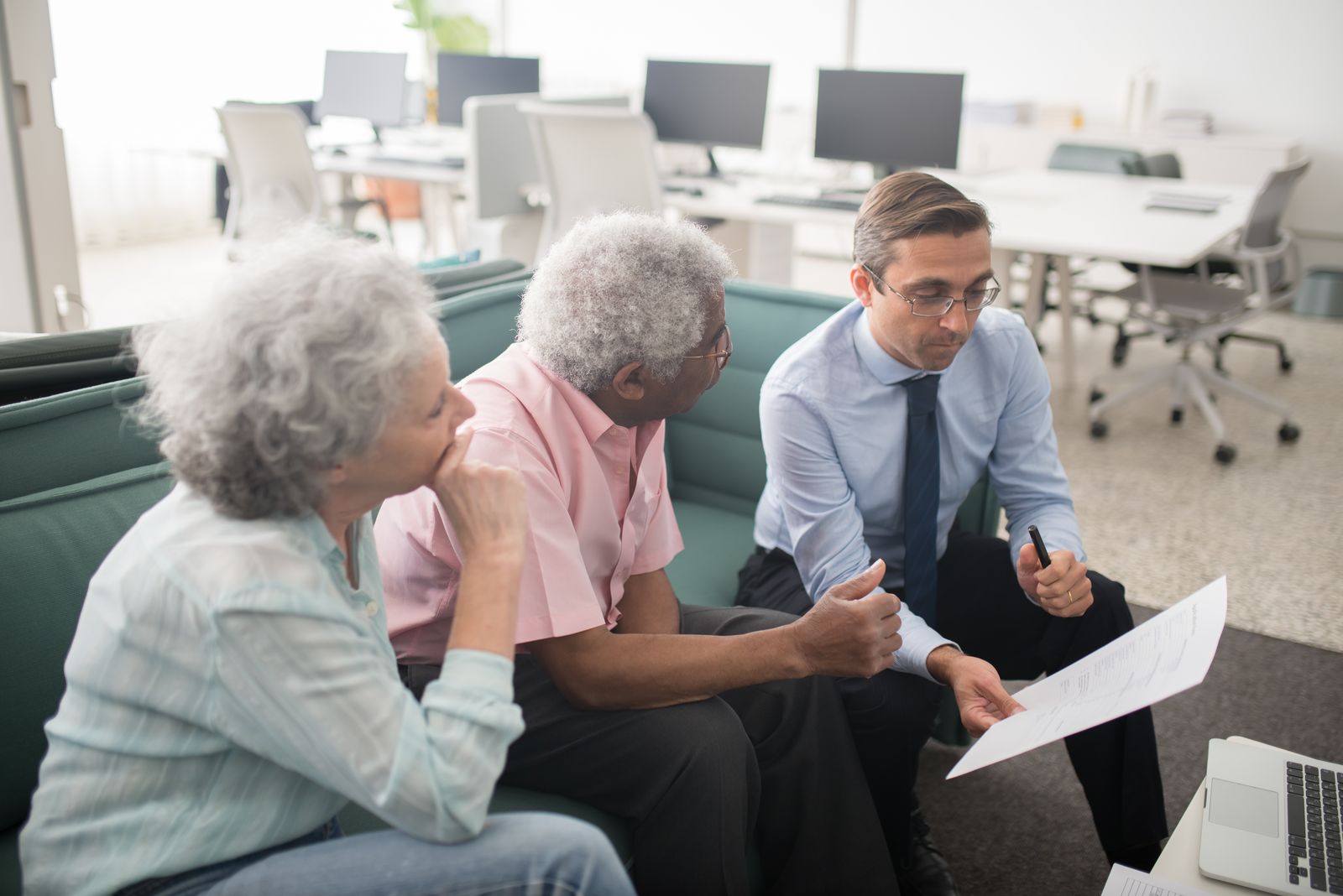 Attorney advising an older couple on estate planning